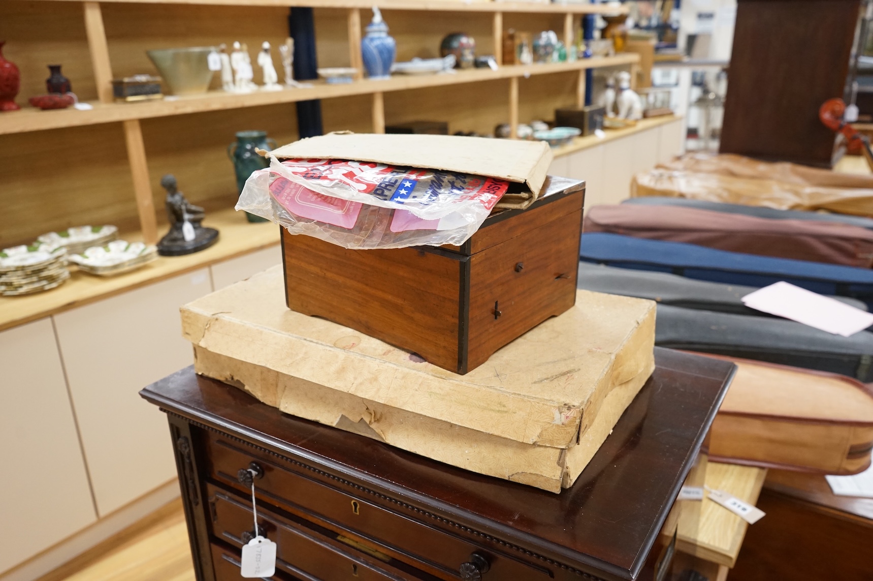 A late 19th century Monopol disc music box in a mahogany case, to play discs 19cm diameter, together with twelve discs, plus an ebonised ‘Chord-Harps’ zither in its original card box with tuning hammer.